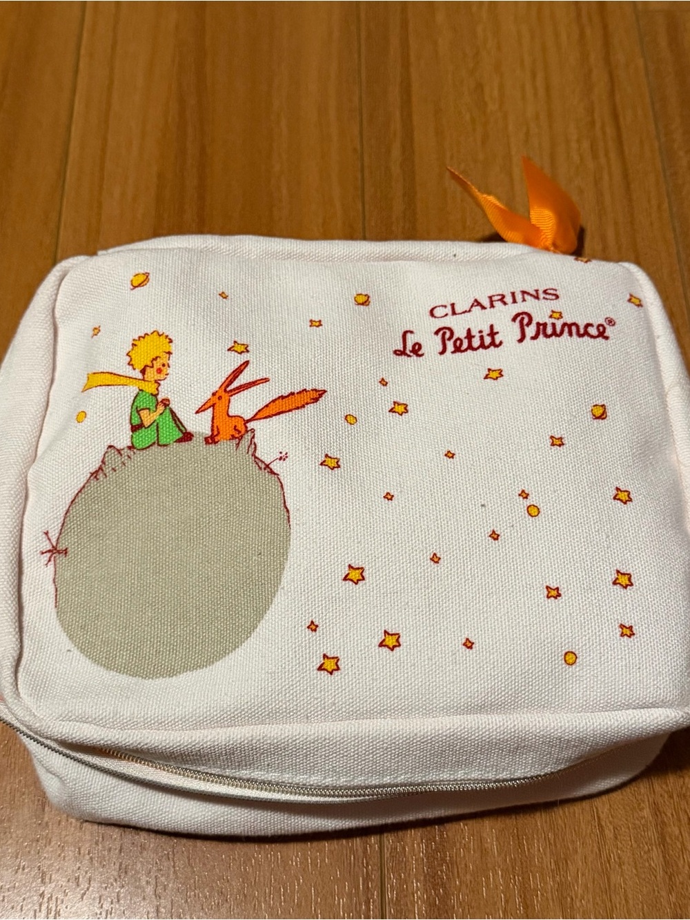 Clarins Canvas Travel Pouch Le Petit Prince in White and Vibrant Orange